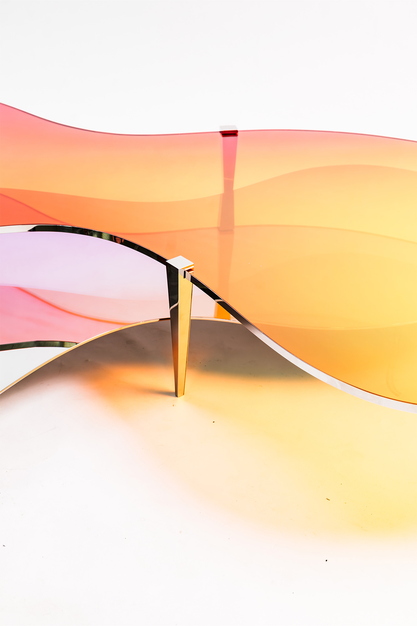 Low Table LT01 by ODA LIK – curved dichroic glass blending light and reflection