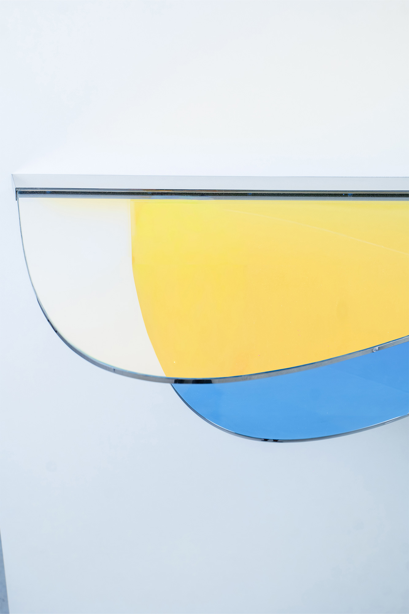 Console C02 by ODA LIK – front view showing mirror-polished steel and glass layers